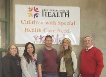 Integrated Services team standing in front of a unit banner